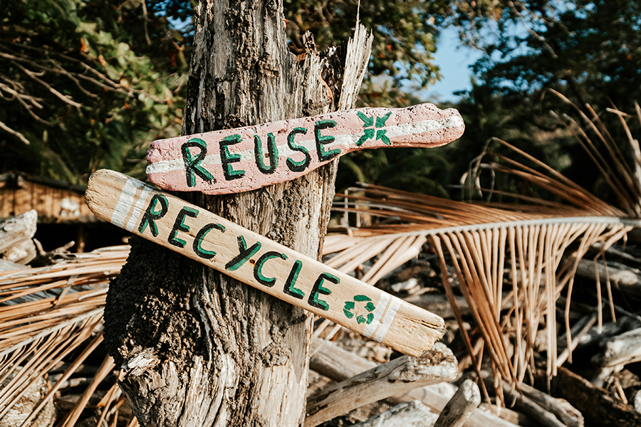Wooden signs say Reuse and Recycle.